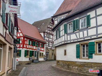 Perspektivischer Blick durch die ruhige, gepflasterte Altstadtstra&szlig;e mit ihren Fachwerkgiebeln