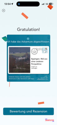 Nahaufnahme der Adventure Lab App auf dem Smartphone mit der Best&auml;tigung der abgeschlossenen Station am Friedhof]