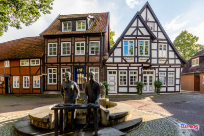 Nahaufnahme des Nienburger Spargelbrunnens aus Bronze in der Fußgängerzone