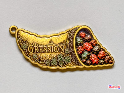 Geocoin in Form eines mythologischen Füllhorns als zentrales Event-Symbol